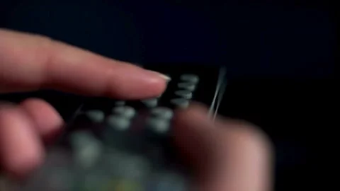 Remote control at the background of the screen TV panels. Close-up of a rem.. Stock Footage 257875500