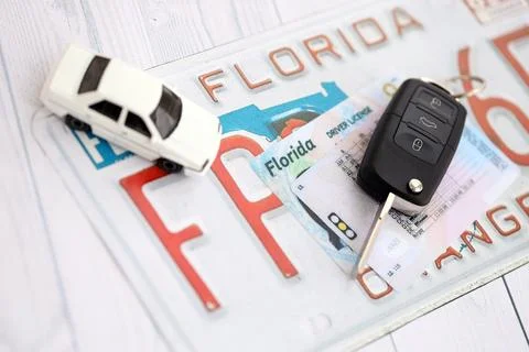 Remote control car keys on Florida license plate with driver license. Car Stock Photos
