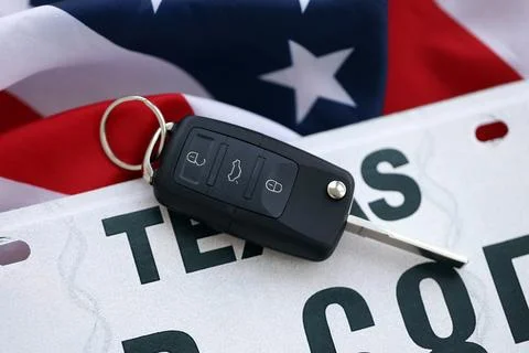 Remote control car keys on Texas license plate on US flag. Car driving in Texas Stock Photos