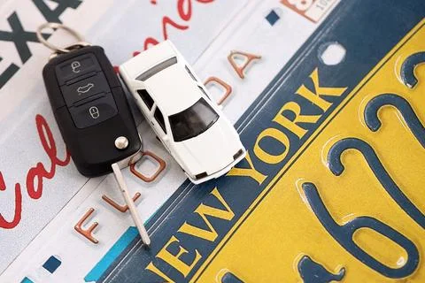 Remote control car keys on US license plates with state names. Driving in United Stock Photos