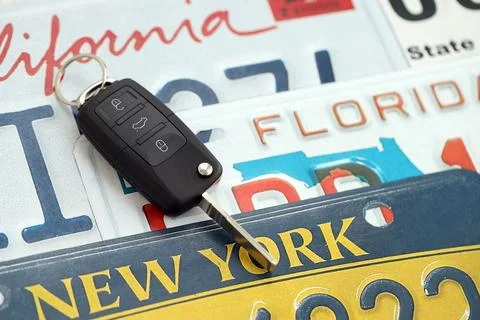 Remote control car keys on US license plates with state names. Driving in United Stock Photos