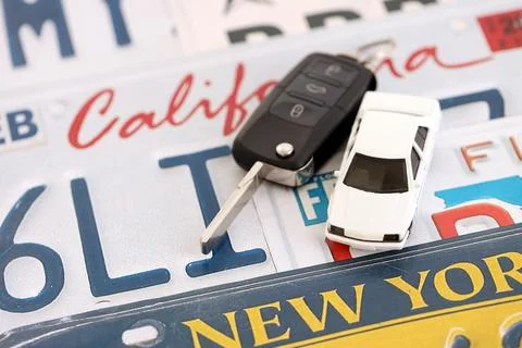 Remote control car keys on US license plates with state names. Driving in United Stock Photos