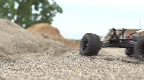 Remote control car kicking up dust slow motion Stock Footage