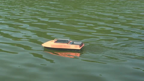 Remote control carp fishing bait boat delivers bait and tackle to chosen point Stock Footage 227515448