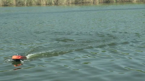 Remote control carp fishing bait boat delivers bait and tackle to chosen points Stock-Footage 243289619