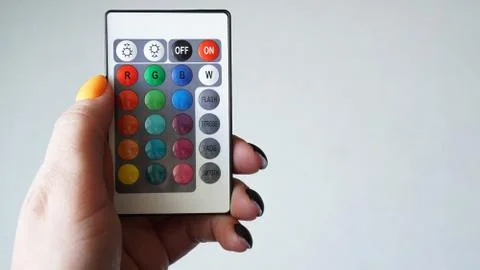 Remote control for change colors in hand isolated on white Stock Photos