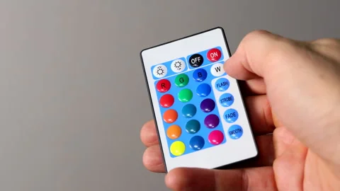 Remote Control for Color LED Strip, Hand Pressing Multicolored Buttons Stock Footage 305663526