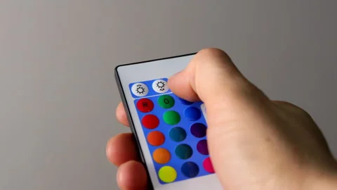 Remote Control for Color LED Strip, Hand Pressing Multicolored Buttons Stock Footage 306009061