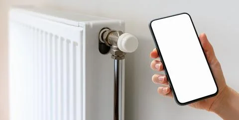 Remote control of domestic heating panel with smart phone and mobile app. Mob Stock Photos