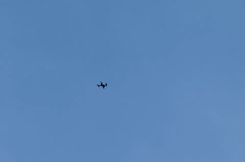 A remote control drone flies high in the sky above Plana mountain Stock Photos