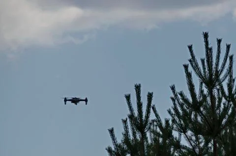 A remote control drone flies high in the sky above Plana mountain Stock Photos