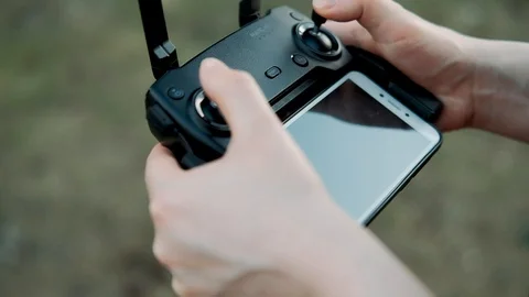 Remote control of the drone in the hands of the girl close-up. Stock Footage 109263310