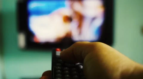 Remote control foreground  change tv with blur background Stock Footage 62991559
