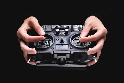 Remote control of FPV racing drone on black background in female hands, cl... Stock Photos