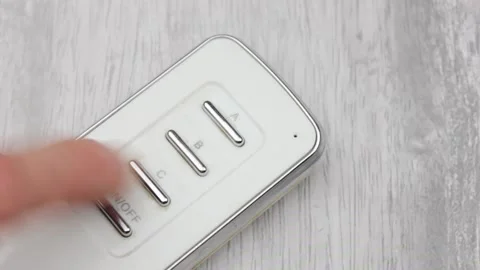 Remote control in hand with a red indicator close-up. Video stock 194289034