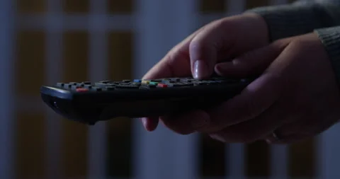 Remote control in hands switching channels 4K 4K+ 5K, RED camera footage Stock-Footage 129364500