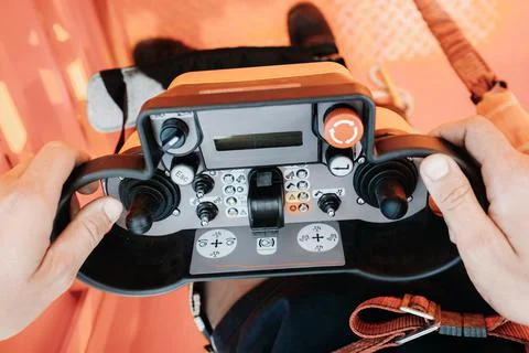 Remote control of a lifting car crane in the hands of a person. Panel with jo Fotos Stock