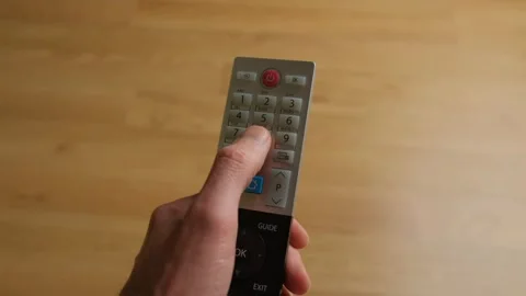 Remote control. A man presses a broken button. Can't change TV channel. Stock Footage 267151729