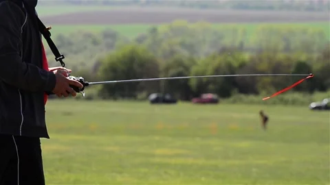 Remote control operated by a man to fly a plane Stock Footage 166458630