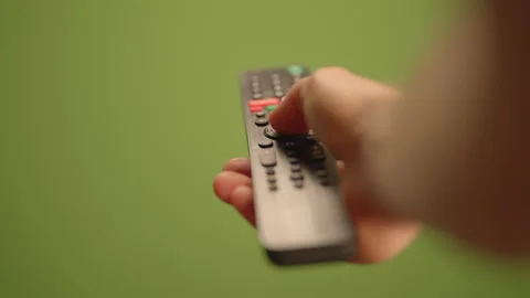 Remote Control Over a Vibrant Green Back... | Stock Video | Pond5