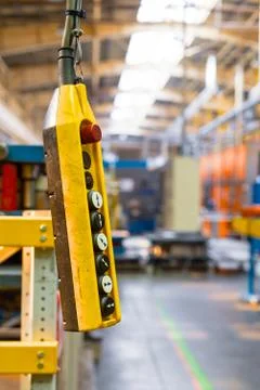 Remote control pendant switch for overhead crane in the factory Stock Photos