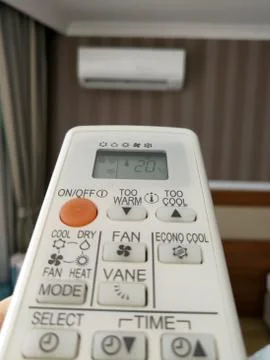 Remote control pointing at air conditioner Stock Photos