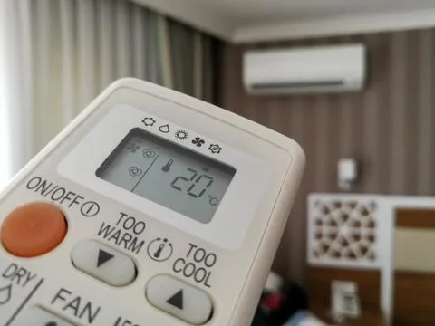 Remote control pointing at air conditioner Stock-Fotos
