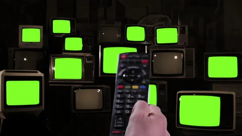 Remote Control Pointing at Stacked Vintage TVs Turning On and Off Green Screens Stock Footage 304006405