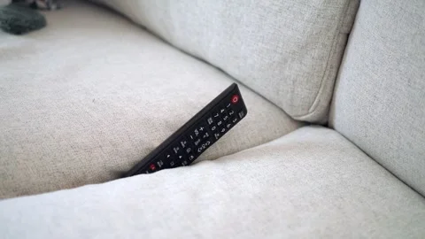 Remote control stuck between couch cushions Stock Footage 340597265