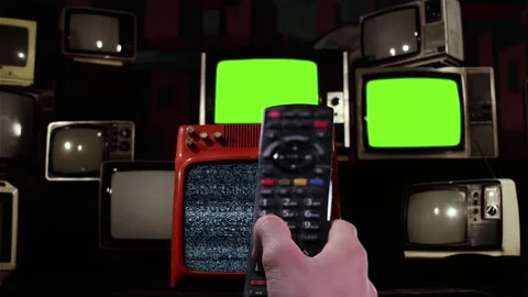 Remote Control Turning On and Off Old TVs With Flickering Green Screens - 4K Stock Footage 304004691