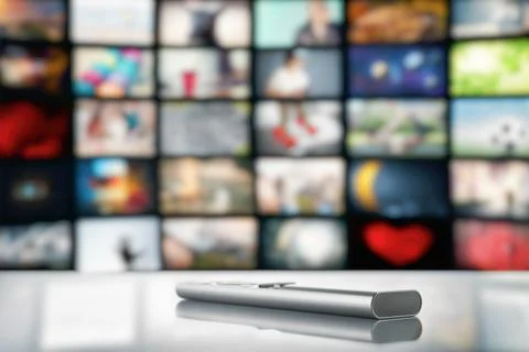 Remote control from tv on the background of a large tv screen Stock Photos