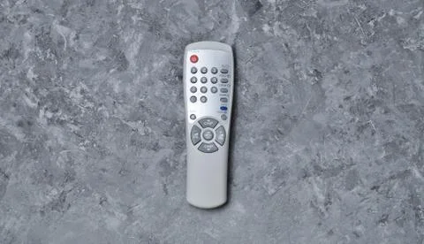 Remote control from TV on a concrete table. Top view. 스톡 사진