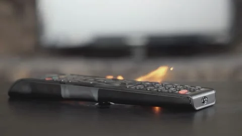 The remote control from the TV LIGHTS UP AND SPARKS on the table in the room,  Stock Footage 153654174