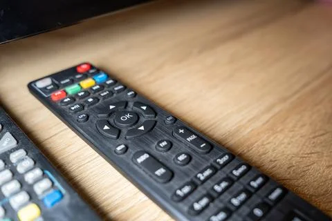 Remote control on wooden table, designed for TV and other multimedia devices, Stock Photos