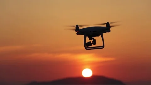Remote controlled drone flying in air and sunset sky Stock Footage 76458034