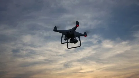 Remote controlled drone flying in the sunset sky Stock Footage 75952000