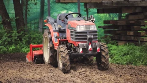 A remote-controlled minitractor loosens ... | Stock Video | Pond5