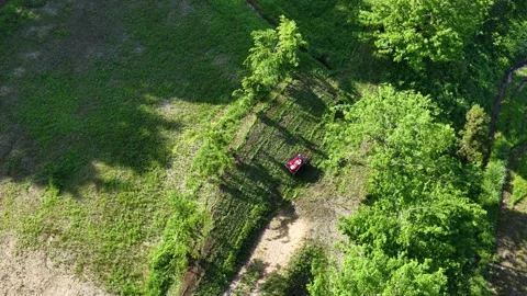 Remote Controlled Mower on Steep Grassy Slope Viewed from Above Stock Footage 336562562
