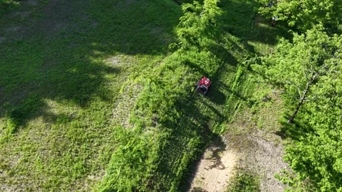Remote Controlled Mower Working Across Vegetated Hillside Stock Footage 336562720