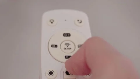 Remote controller of light. A Male Hand Holds a Remote Controller and switches Stock Footage 194080543