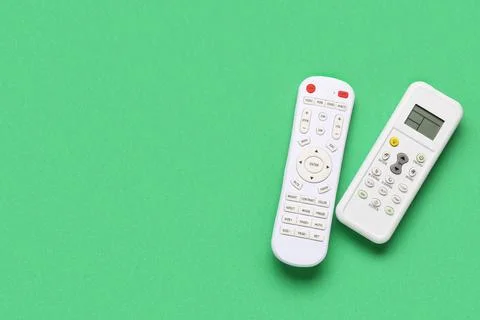 Remote controllers on green background Stock Photos
