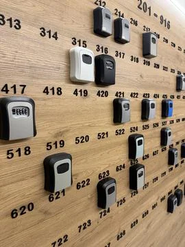 Remote controls on wooden table surface with numeric labels, arranged in va.. 库存照片