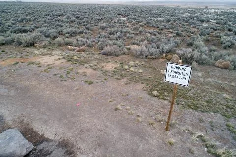 Remote Desert Landscape with Dumping Prohibited Sign Stock Photos