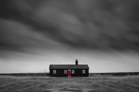 Remote desolate isolated house under dark stormy sky during Winter landscap.. Stock Photos