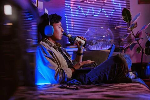 Remote Developer Drinking Beer and Programming 写真素材