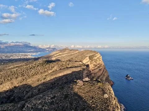 Remote drone image capturing detailed stratified rocks and peaceful maritime Stock Photos