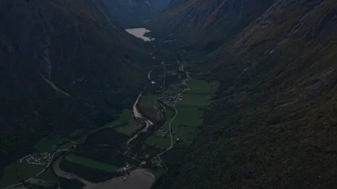 Remote Eikesdalen village seen from above at golden hour in Norwegian fjord Stock Footage 320430113