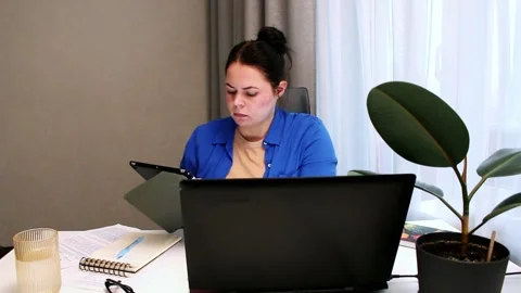 Remote employee analyzing reports during productive workday at home office Stock Footage 321897835