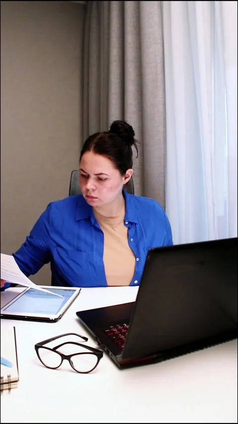 Remote employee analyzing reports during productive workday at home office Stock Footage 327457798
