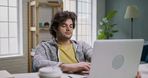 Remote employee working at home, completing his task. Young caucasian freelancer Stock Footage 137257698